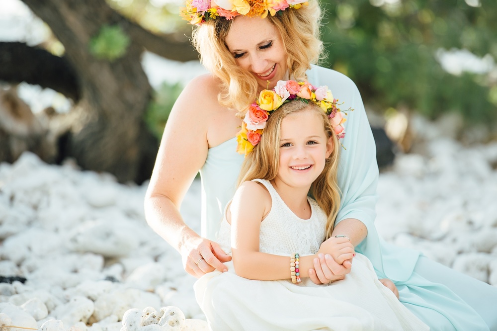 mom and daughter with their colorful floral crowns by photographer