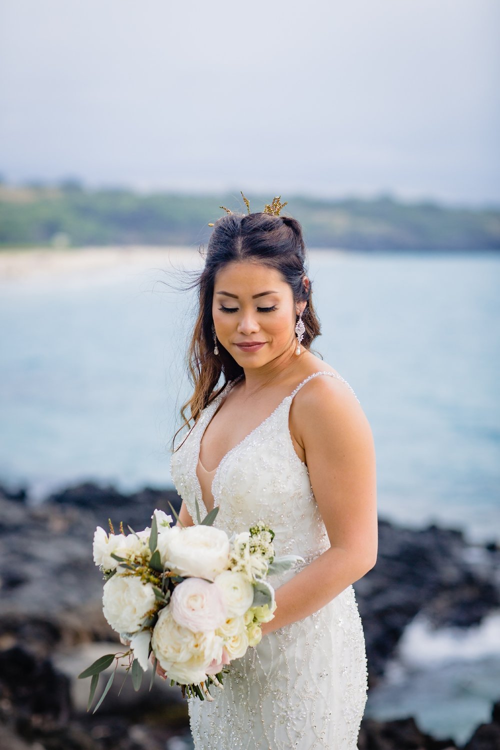 beautiful bride in front of crystal blue hawaii waters