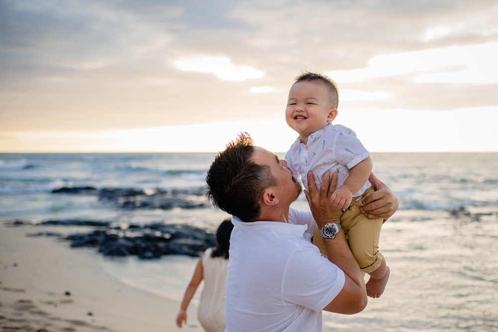 candid photo of dad and son by Hawaii family photographer