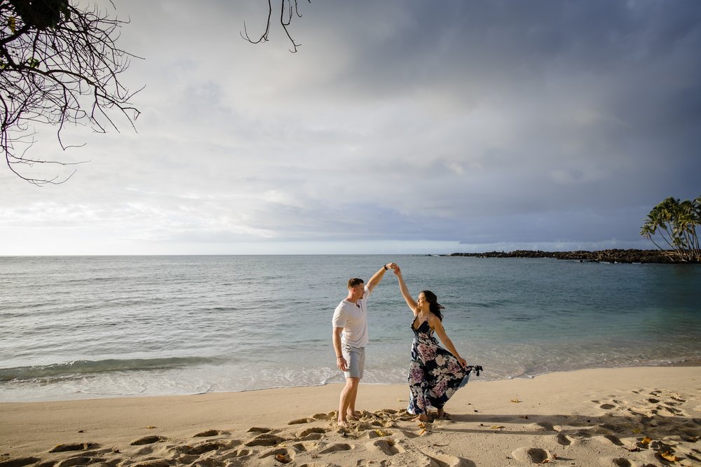 couple twirling at Big Island white beach