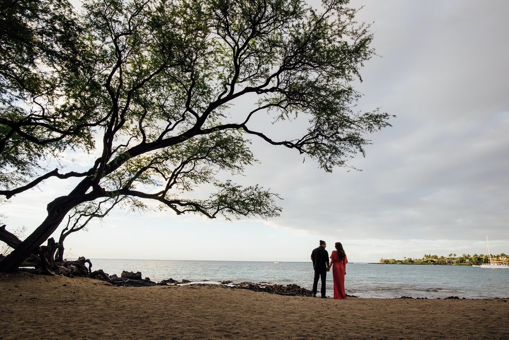 couple holding hands at Kona beach