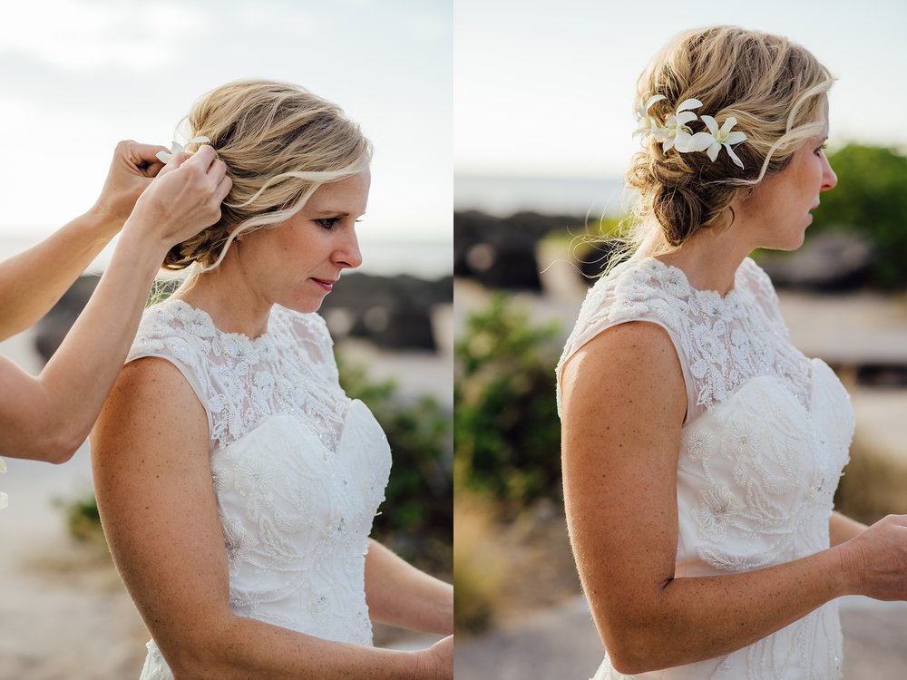 bride putting flowers on her hair at Pine trees beach