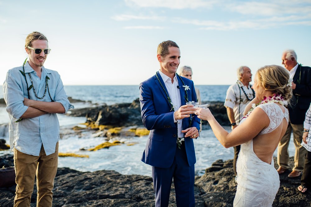 bride and groom having a toast on the lava rocks