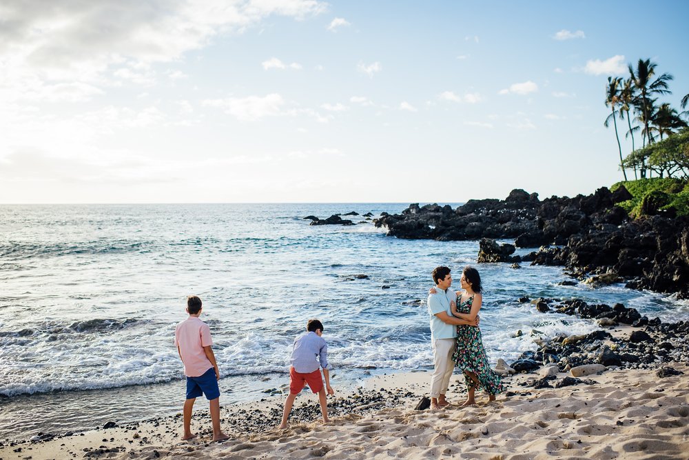 family of four playing at Kona beach 