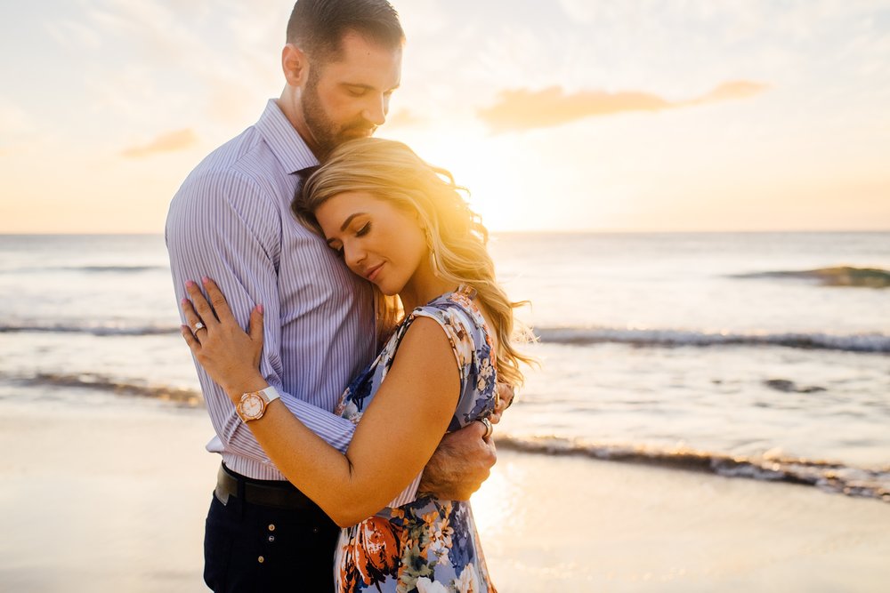 loving him sweet embrace on the beach in Kona Hawaii engagement