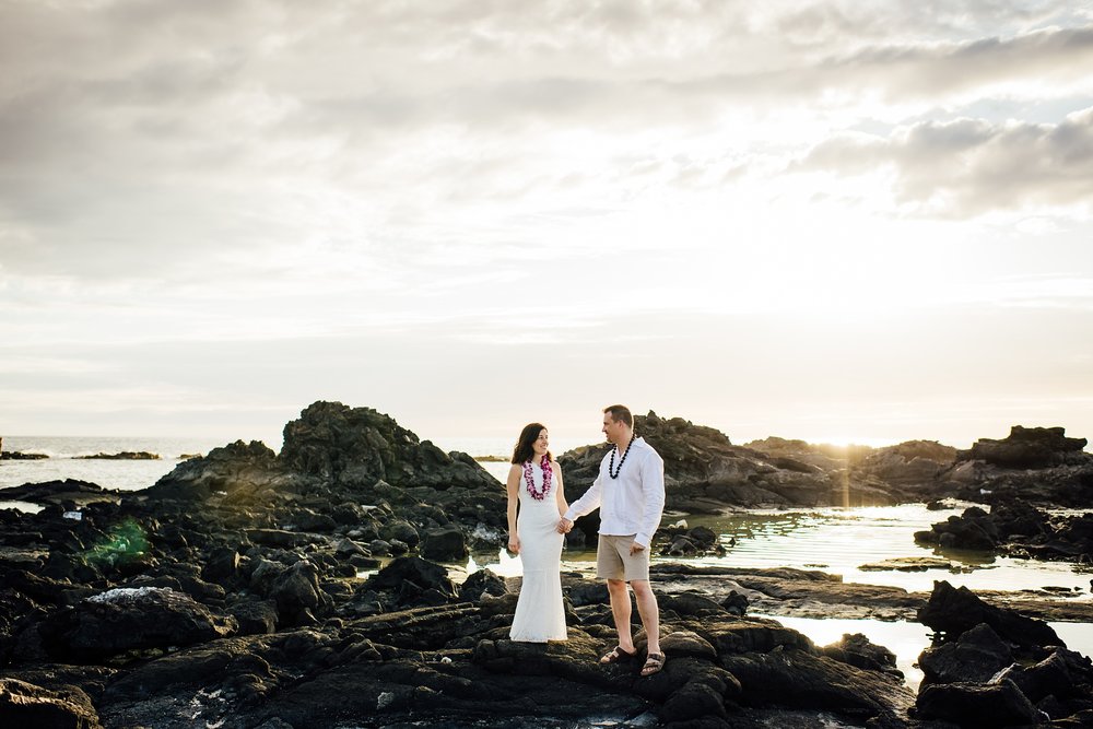 bride and groom holding hands by Hawaii elopement photographer