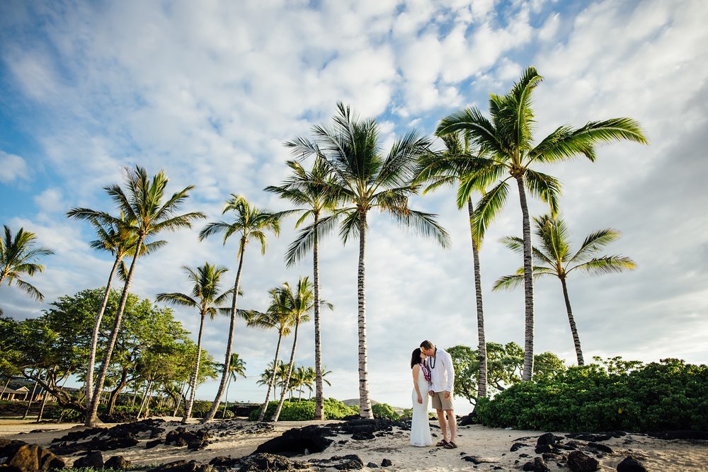 newlyweds kissing under the Pine trees by Hawaii elopement photographer