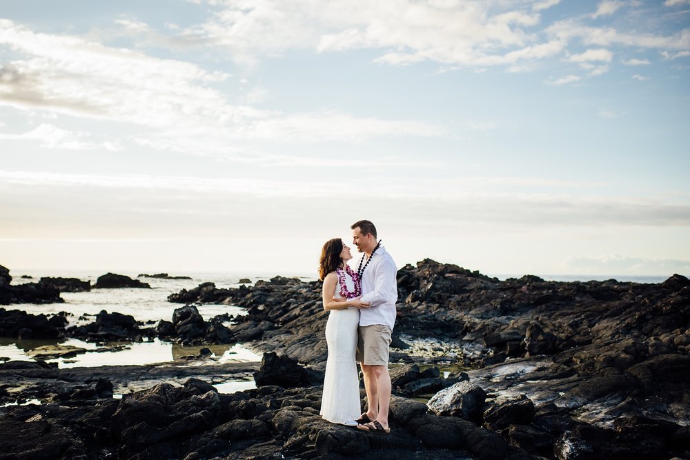 bride and groom standing on the Big Island lava rocks