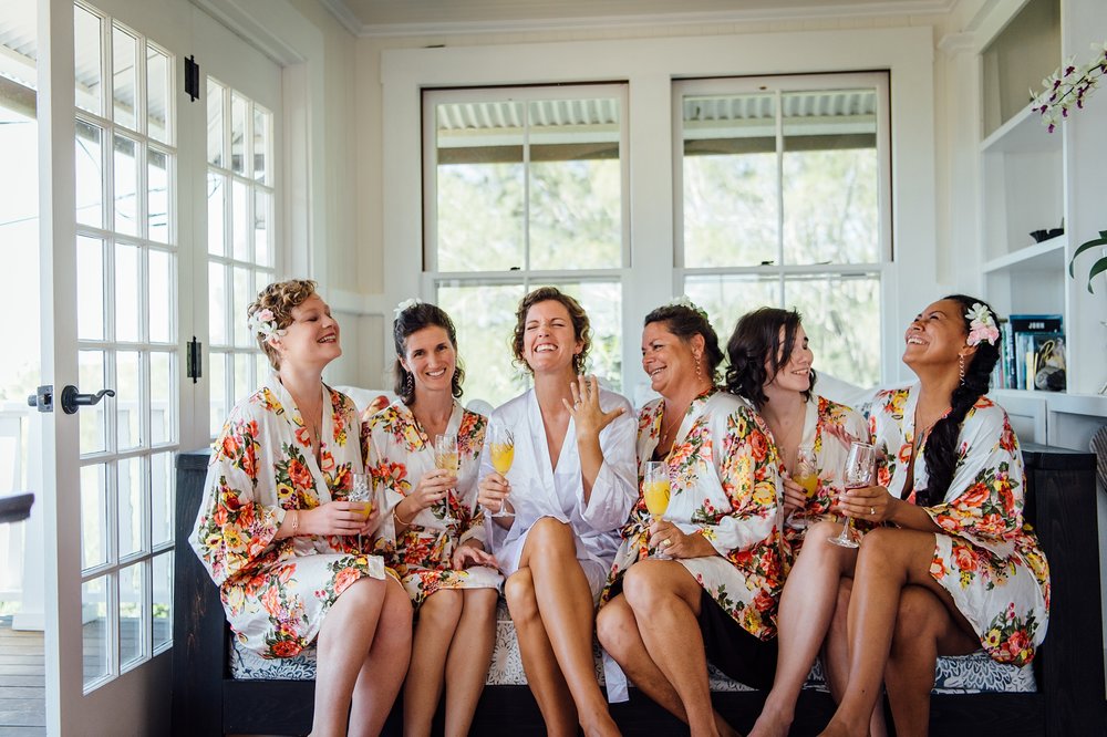 happy bride with her bridesmaids in their robes 