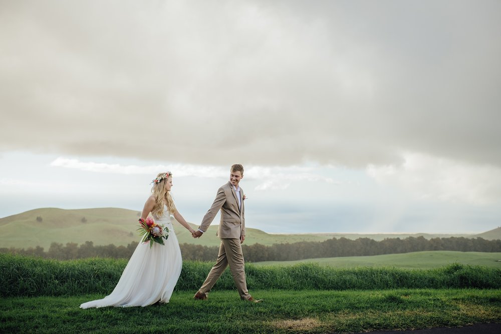bride and groom holding hands at Kahua Ranch