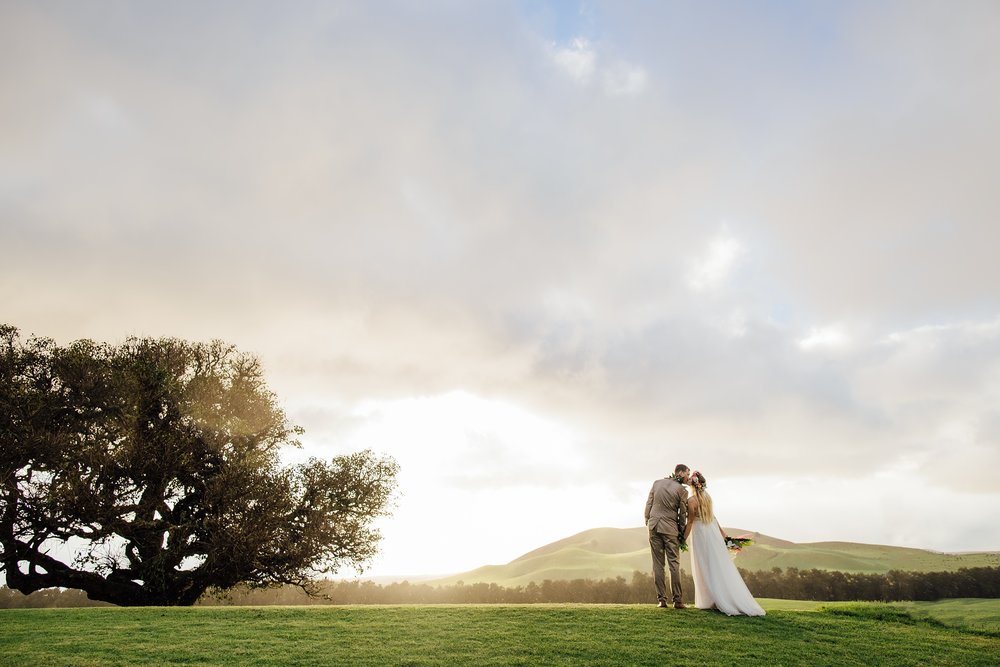 bride and groom kiss during Kahua ranch Sunset 