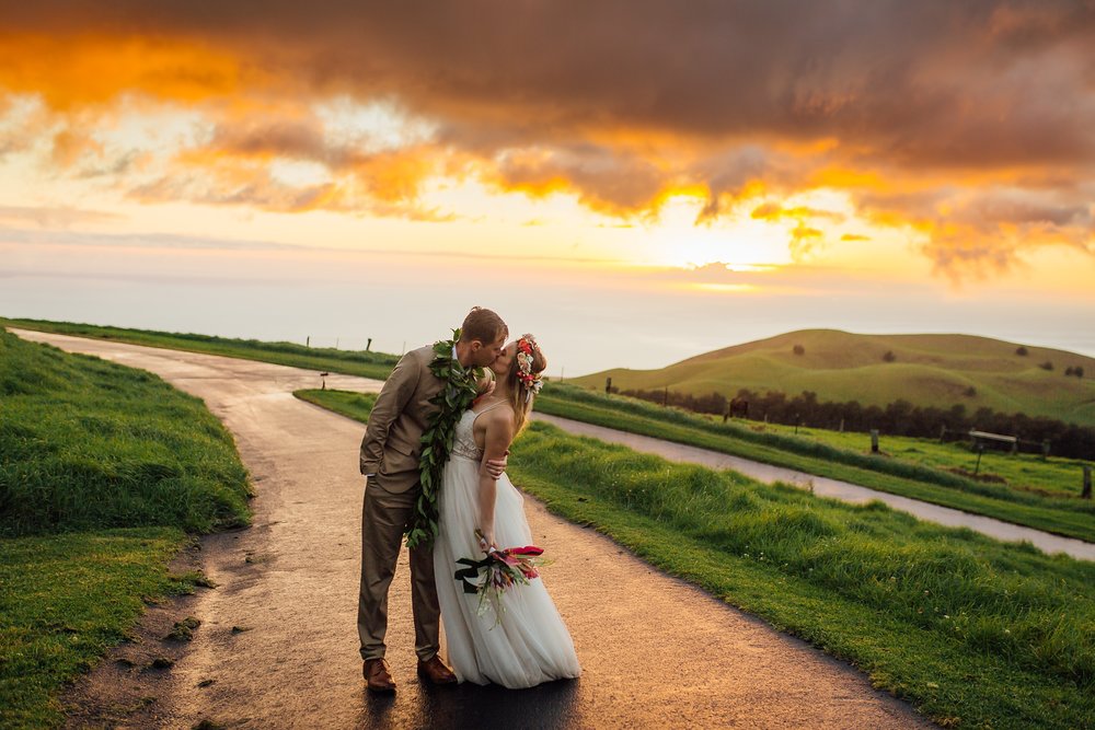 couple kissing during sunset at Kahua Ranch