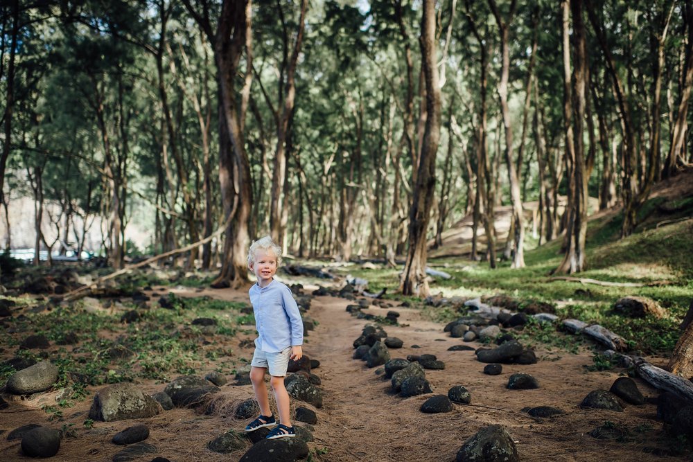 candid photo of a boy in the pololu valley forest