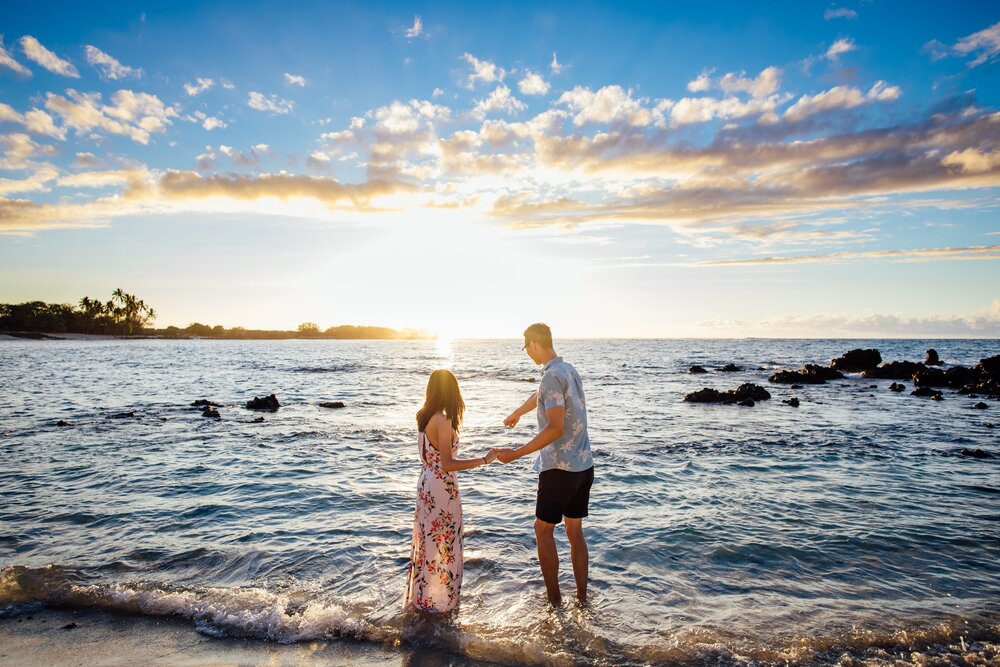 Couple getting in the water during their Big Island engagement session