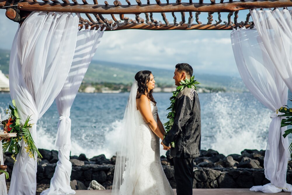 Waves crashing as couple exchange vows on wedding day on the Big island of hawaii