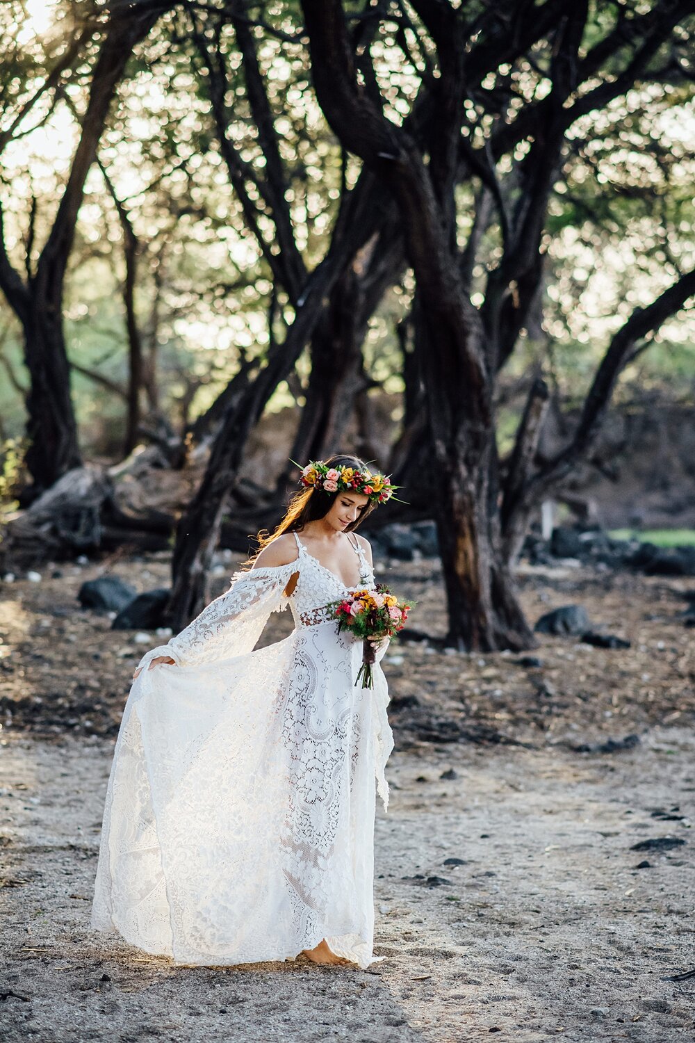 big island bride showing details on her beautiful bohemian lace dress at kiholo beach