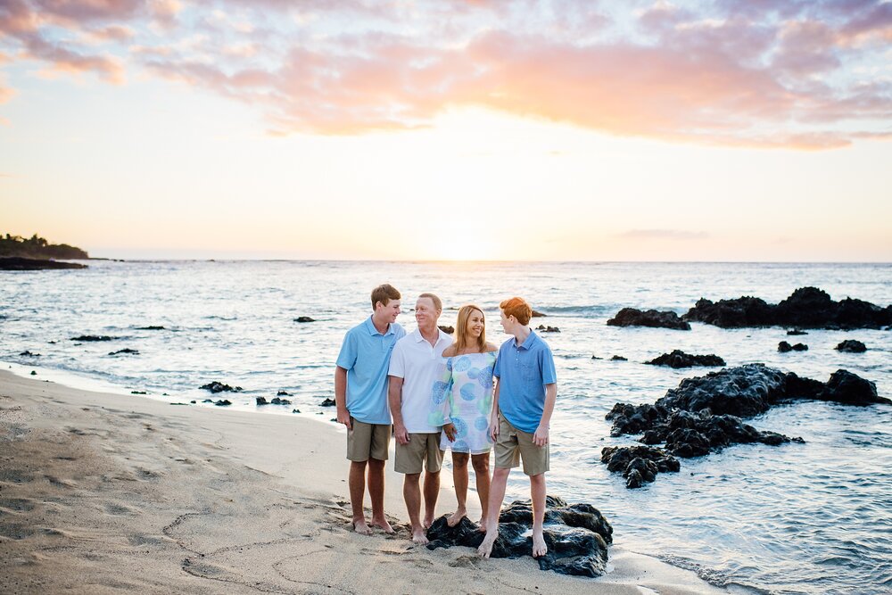 family in Waikoloa Anaehoomalu beach during sunset