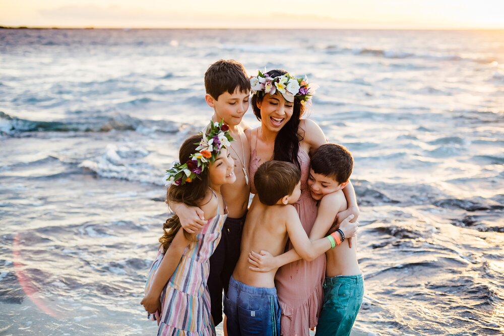 Hawaii mama loving on her babies at a beach in Kona