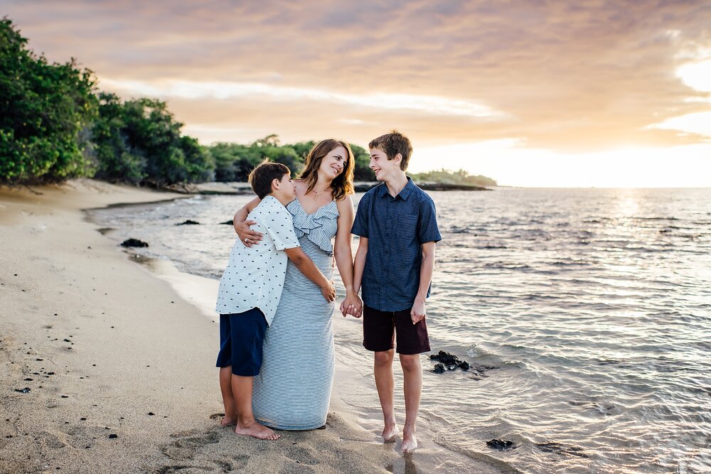 tender moments between mom and her teenage boys in waikoloa at sunset
