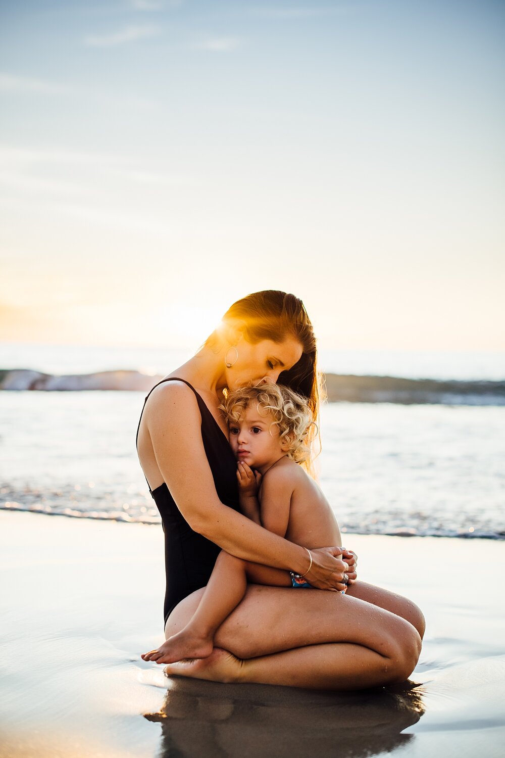 ocean sunset session with mama and baby in their swimsuits