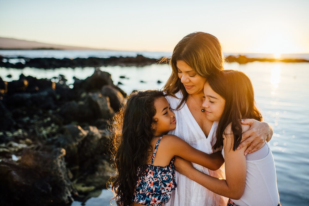 mama loving on her two little girls during their family photography session in waikoloa big island