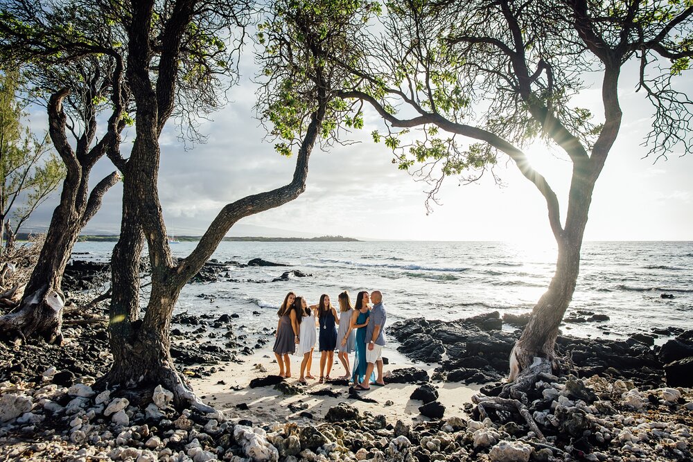 family under the trees at Hawaii beach