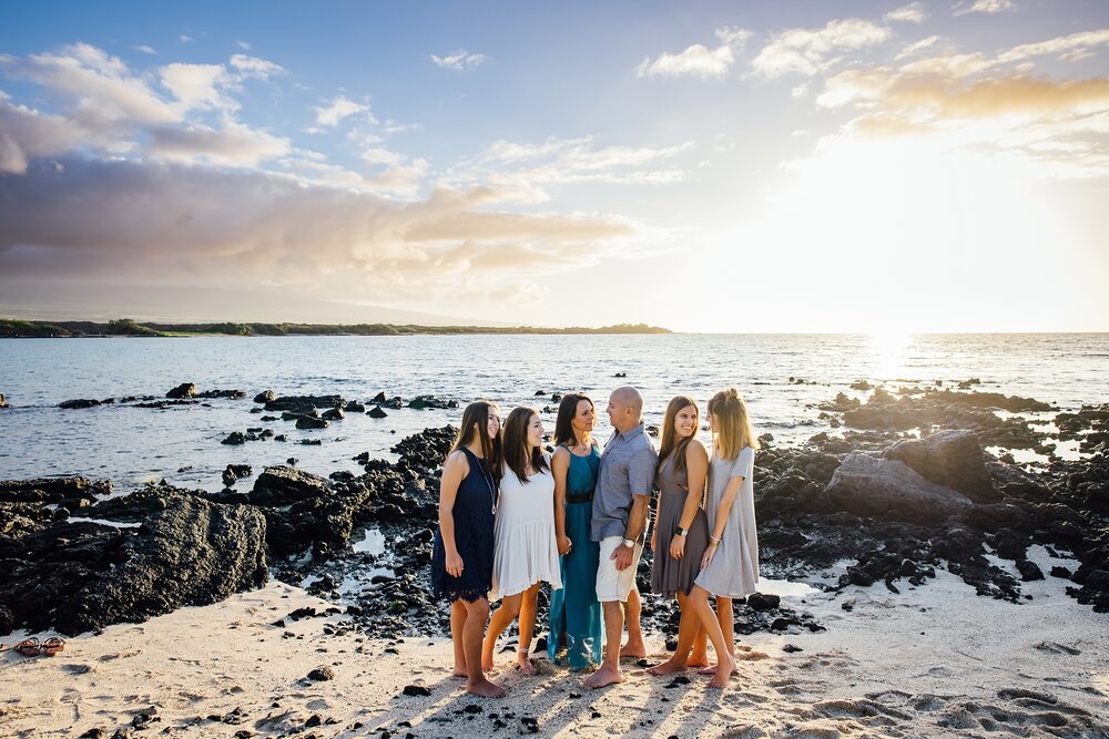 radiant sunset behind the family during Hawaii vacation