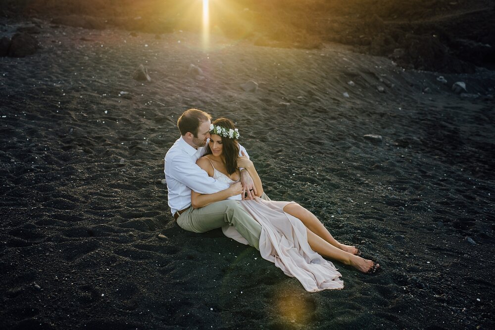 stunning sunset behind the couple at black sand beach