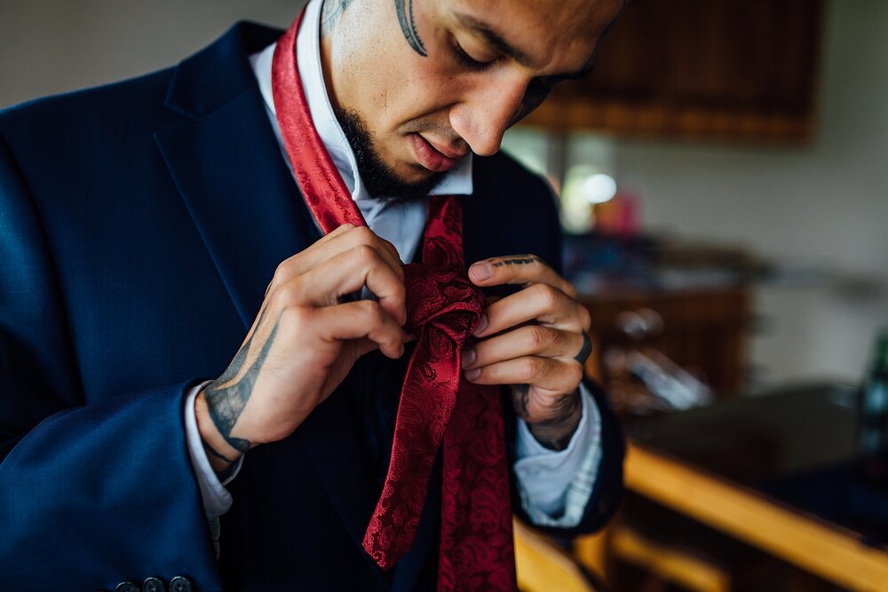 groom tying his necktie
