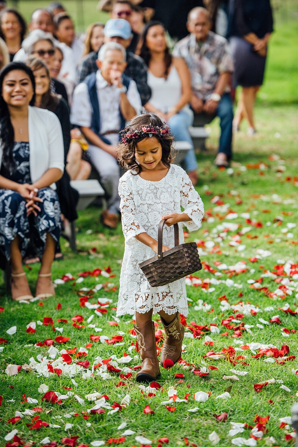 flower girl spreading petals on the wedding aisle