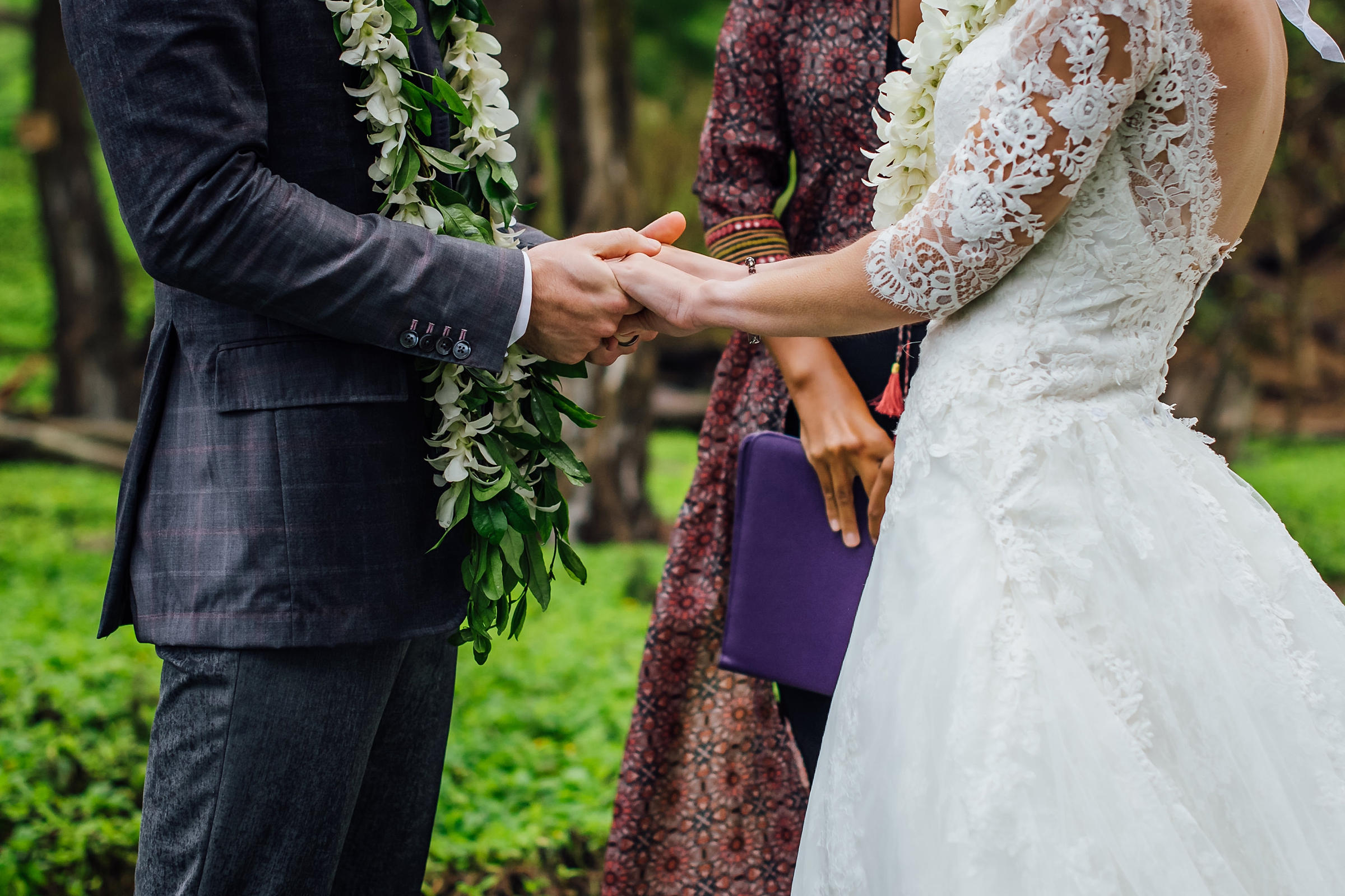 couple holding hands while eloping in Hawaii