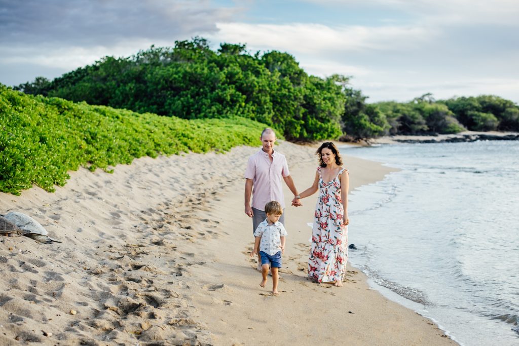 family walking on the beach by Big Island photographer