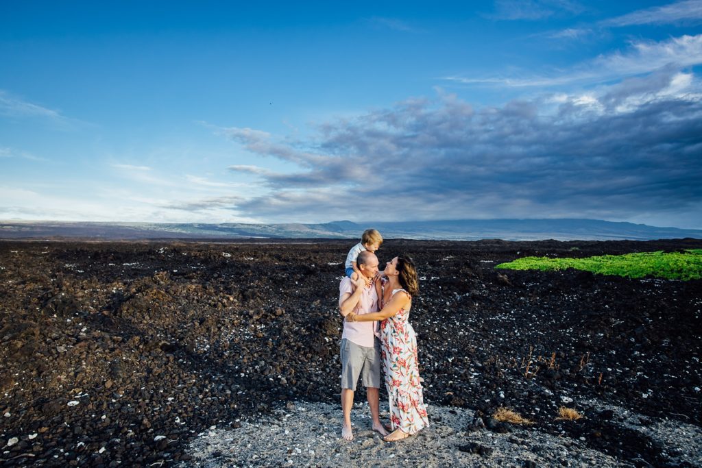 family on lava rocks field by Big Island photographer
