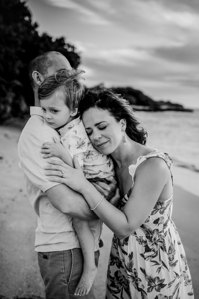 mom hugging son and dad by family big Island photographer