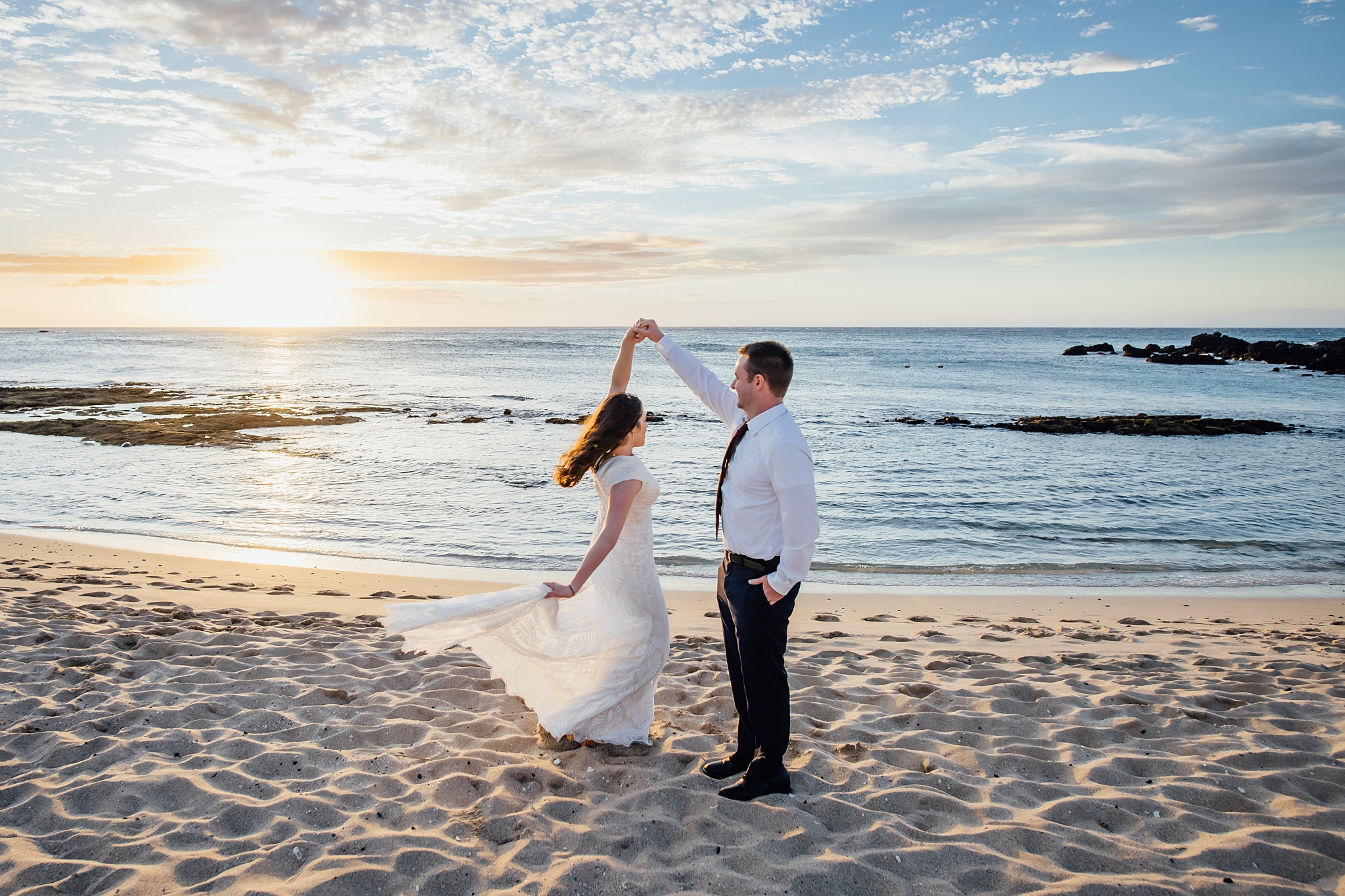 wedding couple dancing in the sunset at the beach