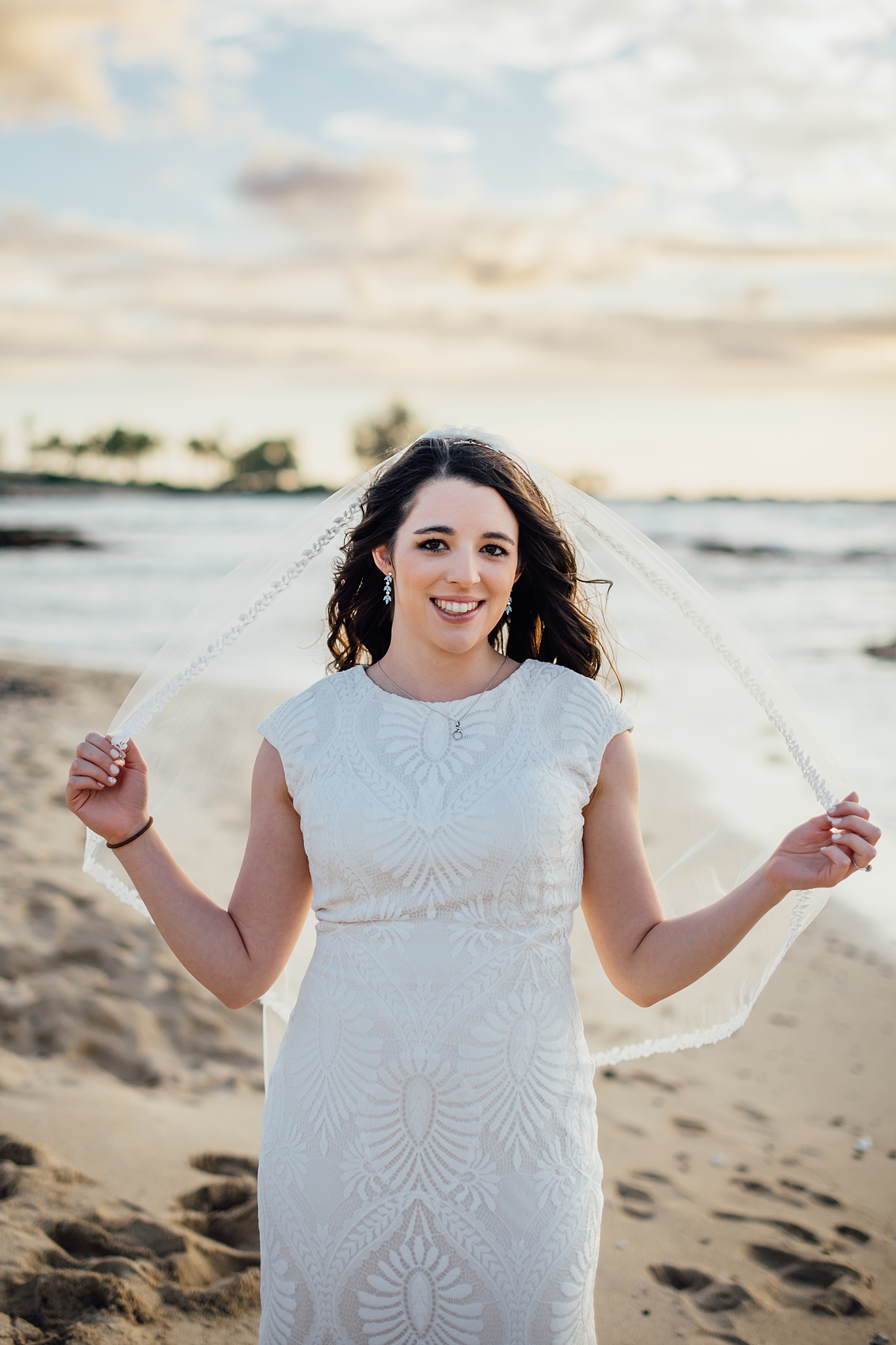 beautiful bride in hawaii holding her veil