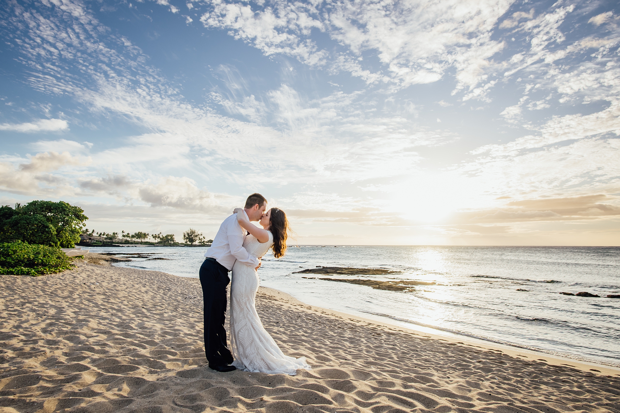 wedding couple and kissing at the beach during Hawaii wedding