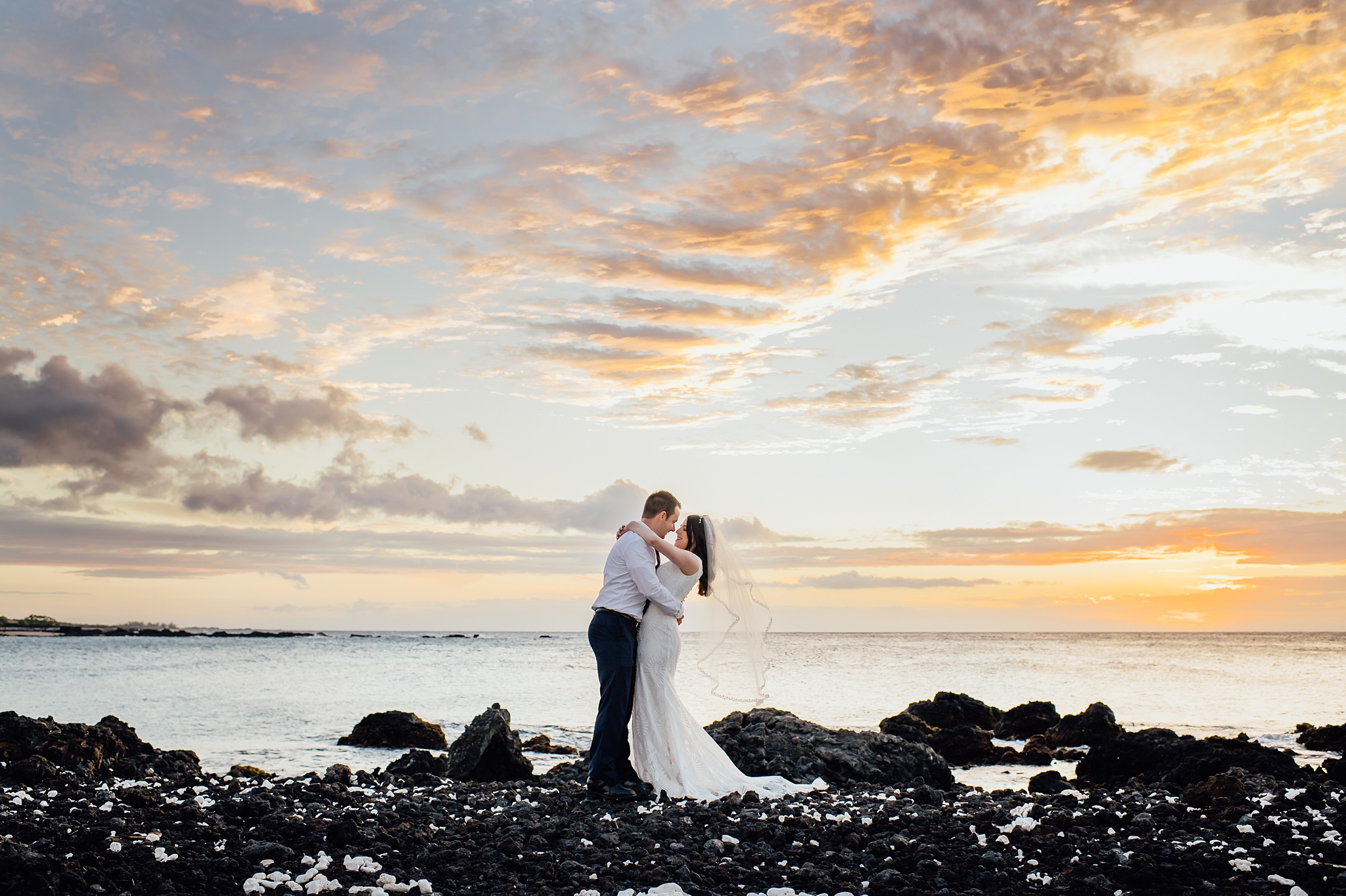 couple embracing under sunset during Kona wedding