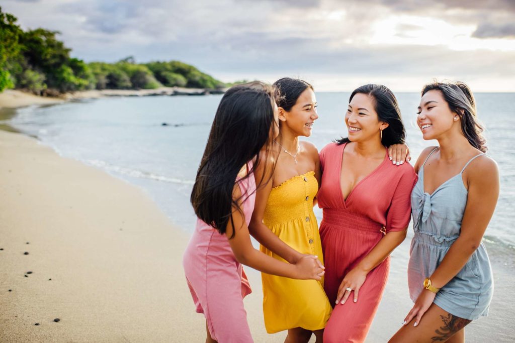 mom and daughters bonding at the Hawaii beach