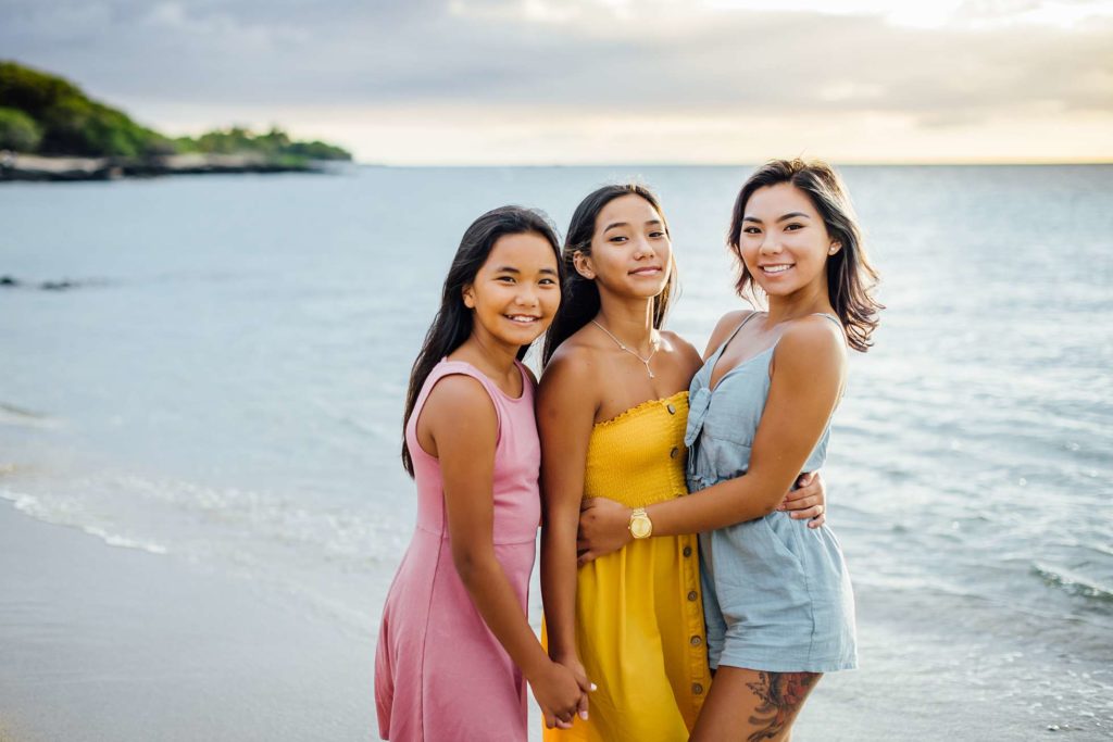 three gorgeous sisters on the beach during Hawaii sunset