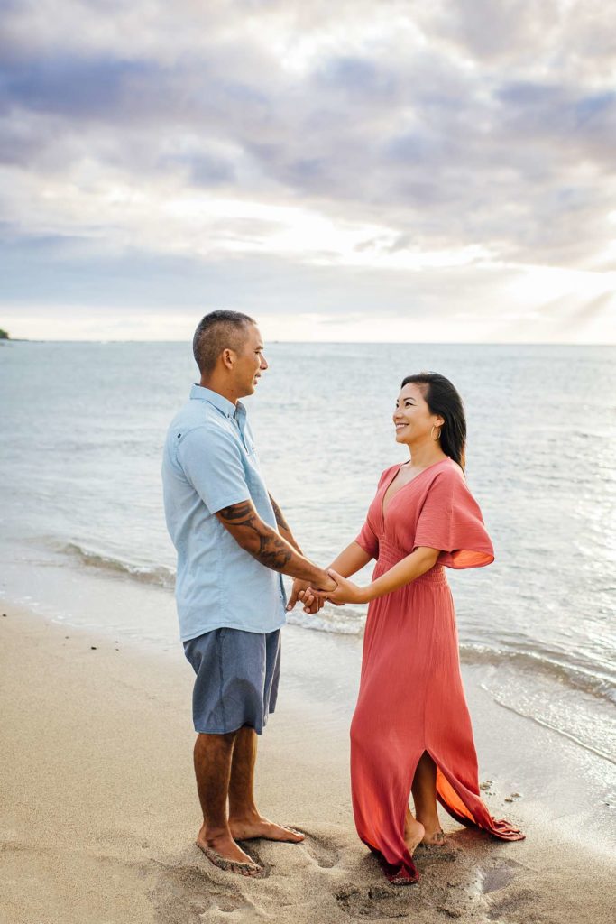 couple holding hands at a beach in Hawaii