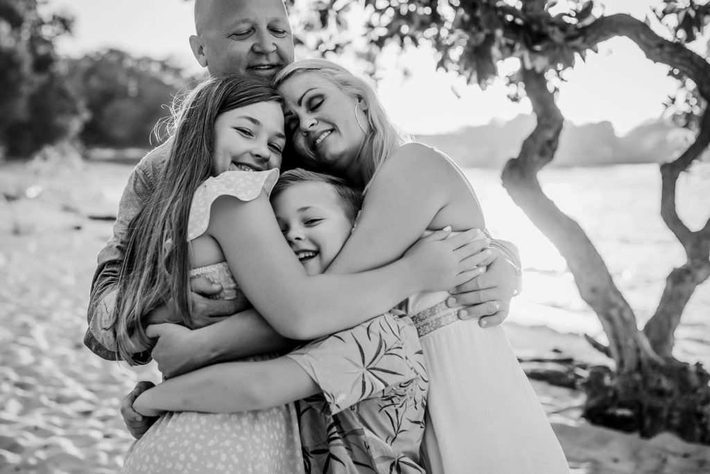 family group hug celebrating a wonderful trip to Hawaii