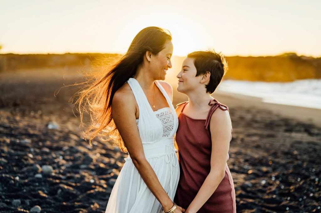 mom and daughter's sweet moments on the beach during sunset