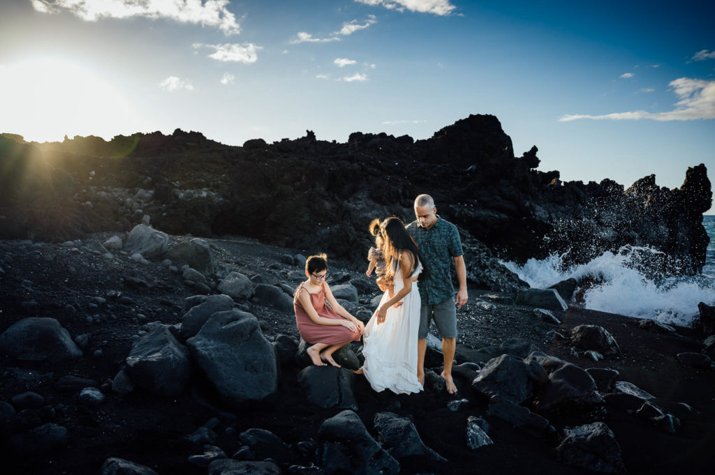 family settling down on the big rocks at Kiholo bay