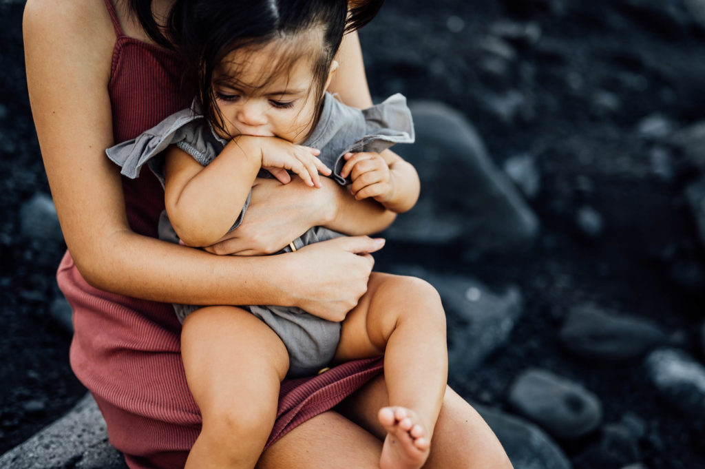 little girl biting her hand by Big Island photographer