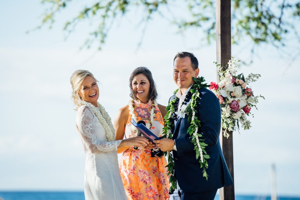 bride and groom laugh during funny moment at their destination wedding in Hawaii