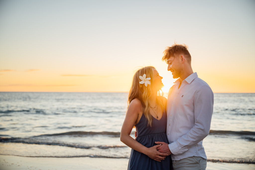 beach golden hour with parents-to-be by Kona photographer
