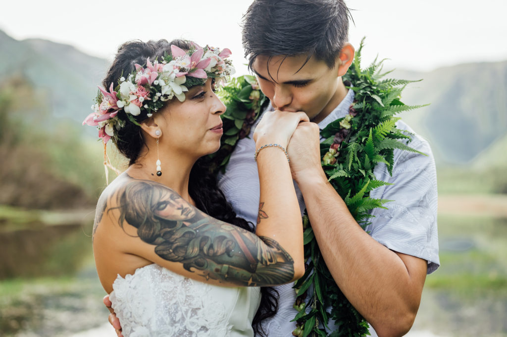 newlyweds on a cliff at this Big Island adventure elopement