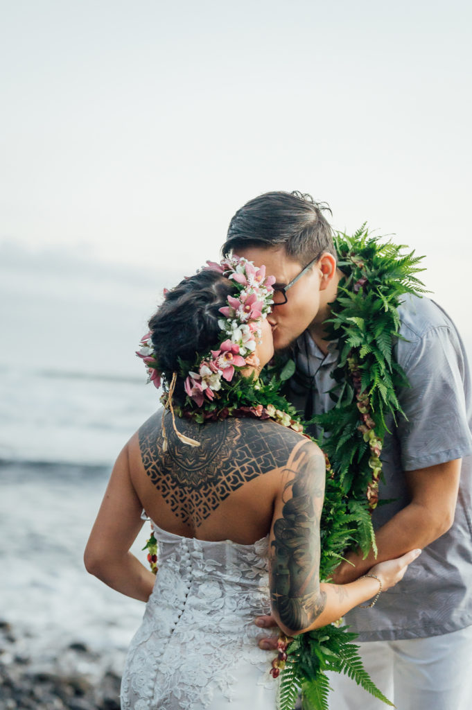 bride and groom kiss during beach elopement