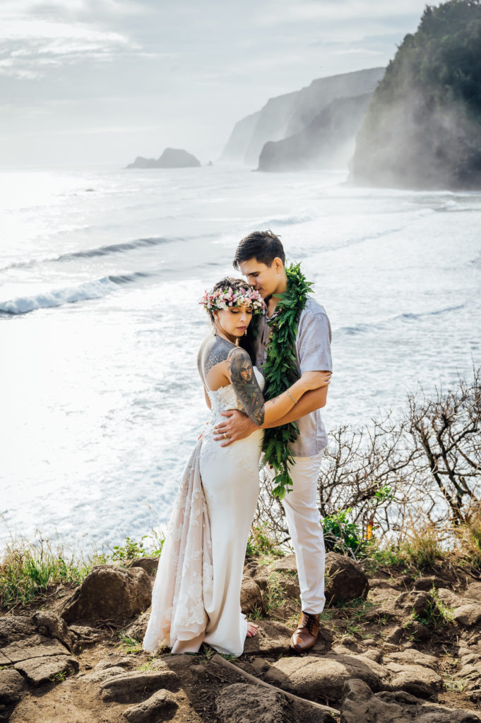 bride and groom on a cliff at this destination wedding in Hawaii